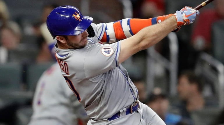 The Mets' Pete Alonso swings for an RBI triple off...