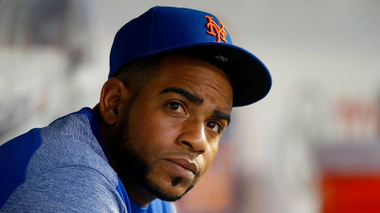 Yoenis Cespedes looks on from the Mets dugout during a...