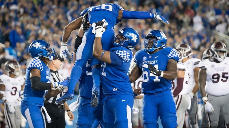 Kentucky running back Benny Snell Jr. is hoisted in celebration following...