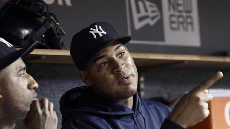 New York Yankees pitcher Ivan Nova sits in the dugout...