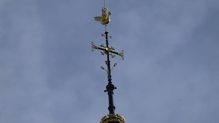 The cross and the rooster atop the Notre Dame de...