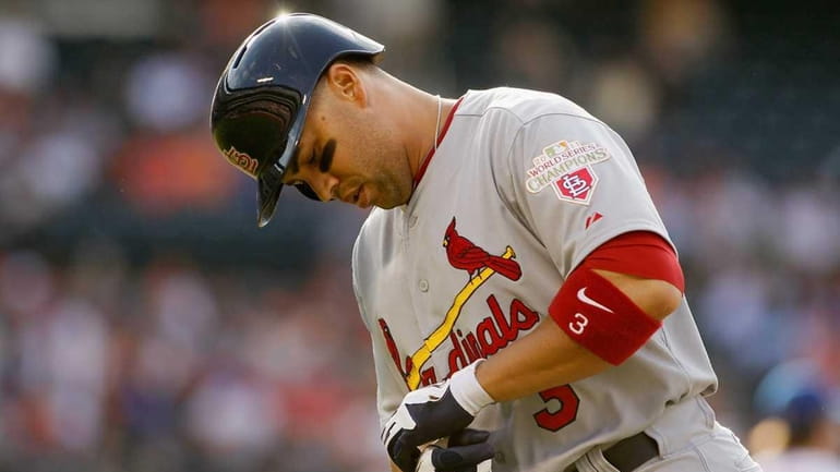 Carlos Beltran #3 of the St. Louis Cardinals reacts after...
