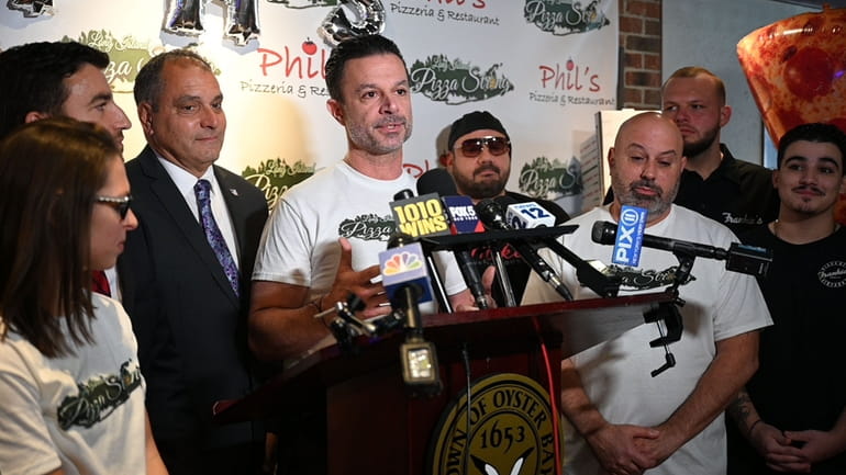 Anthony Laurino, center, owner of Phil’s Pizzeria in Syosset and...