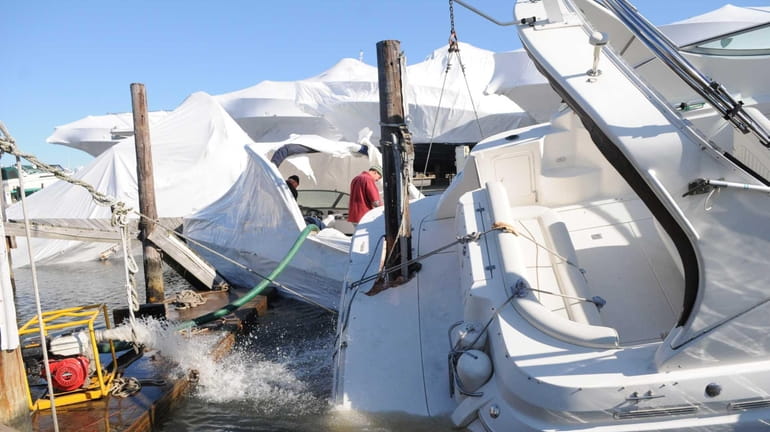 Boats are salvaged at the Anchorage Marina in Lindenhurst in...