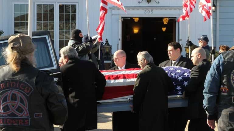 The coffin of Army Sgt. Bill McKenna is carried out...