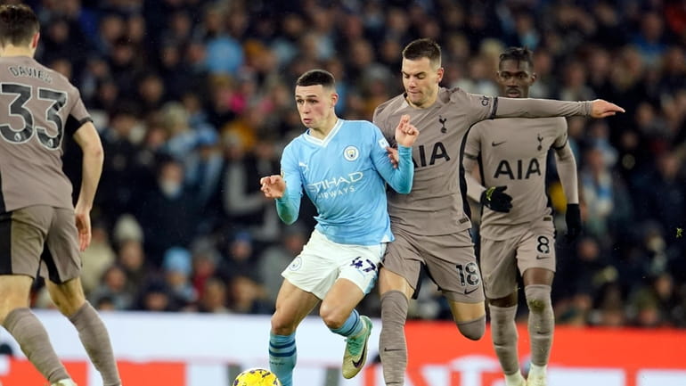 Tottenham's Giovani Lo Celso vies for the ball with Manchester...