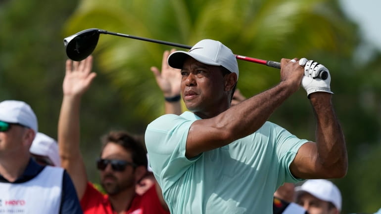 Tiger Woods watches his shot on the fourth tee during...