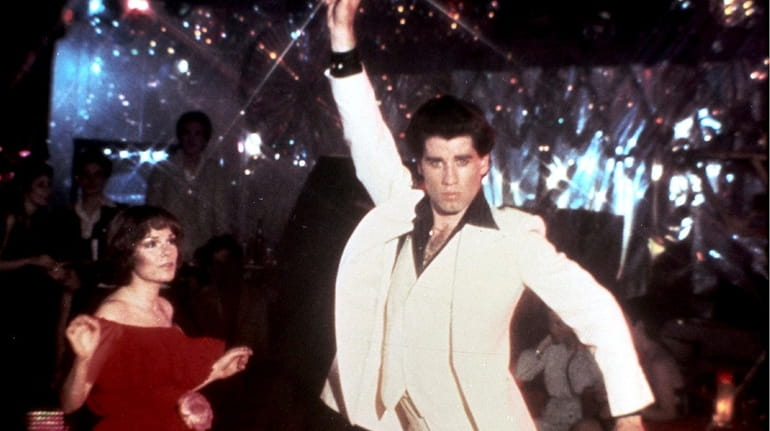 John Travolta strikes his iconic dance pose with Karen Lynn...