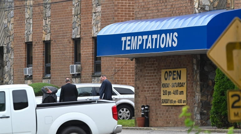 Investigators probe car at scene of shooting outside the Temptations...