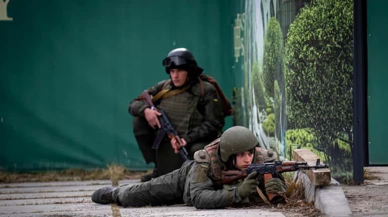Ukrainian soldiers take positions in downtown Kyiv, Ukraine, Friday.
