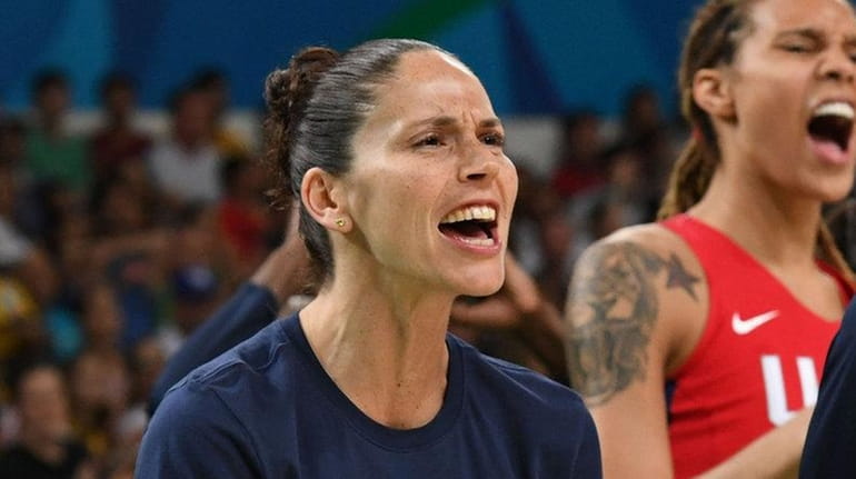 USA guard Sue Bird, left, celebrates a basket during women's...