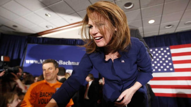 Michele Bachmann greets her supporters after speaking at her caucus...