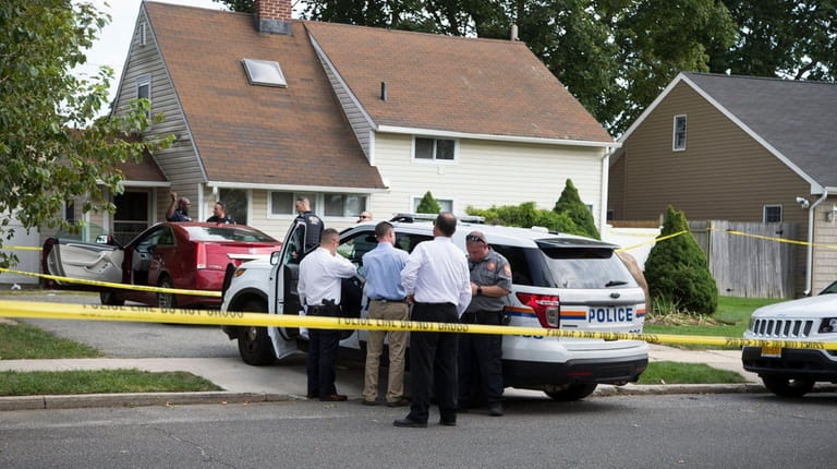 Nassau County police investigate the scene of a homicide in...