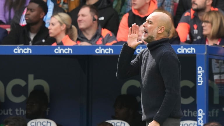 Manchester City's head coach Pep Guardiola reacts during the English...
