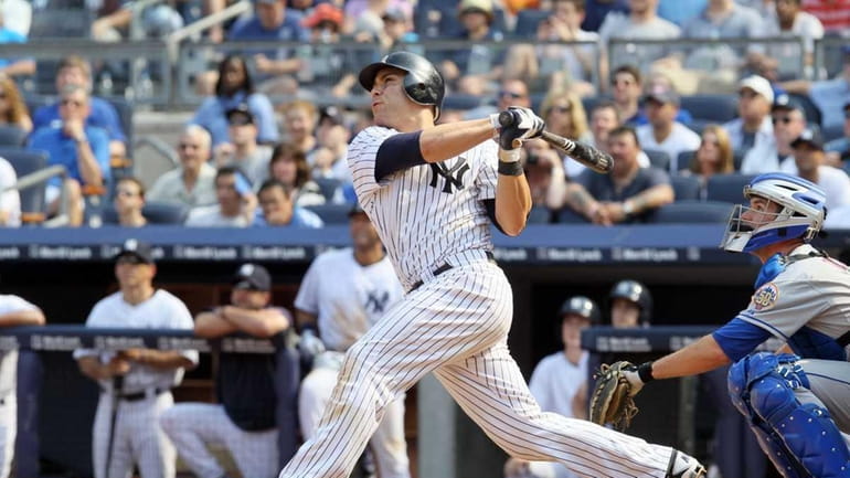 Russell Martin (55) of the New York Yankees follows through...