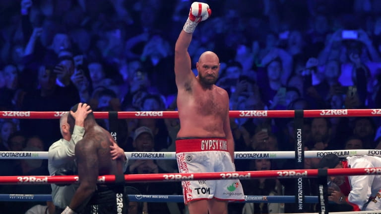 FILE - Britain's Tyson Fury, center, celebrates after beating Britain's...