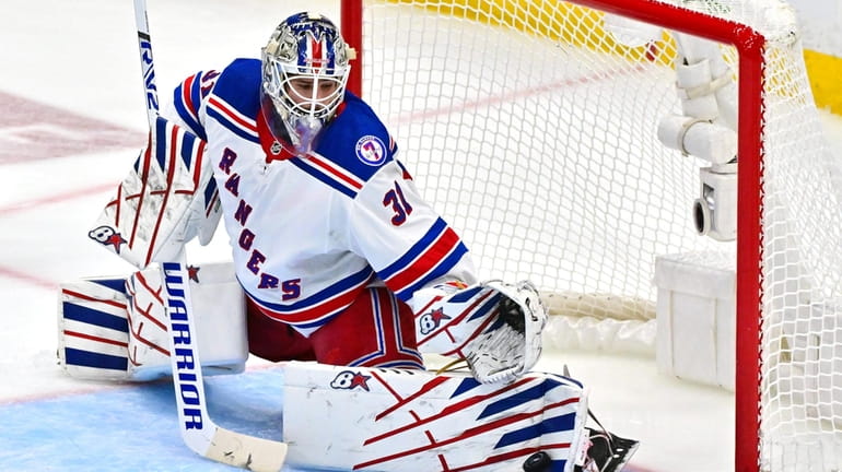 Igor Shesterkin of the Rangers makes a kick save against the...