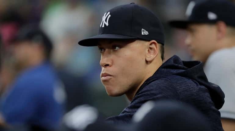 Yankees outfielder Aaron Judge watches from the dugout against the...