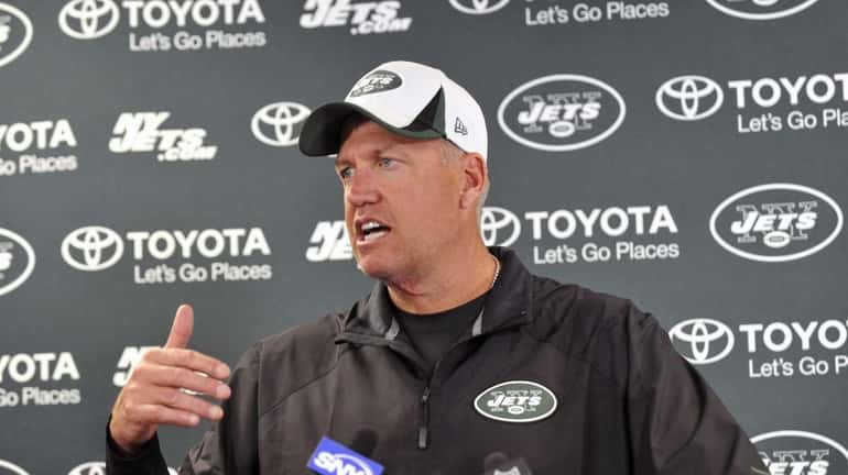 Jets head coach Rex Ryan talks with reporters during training...