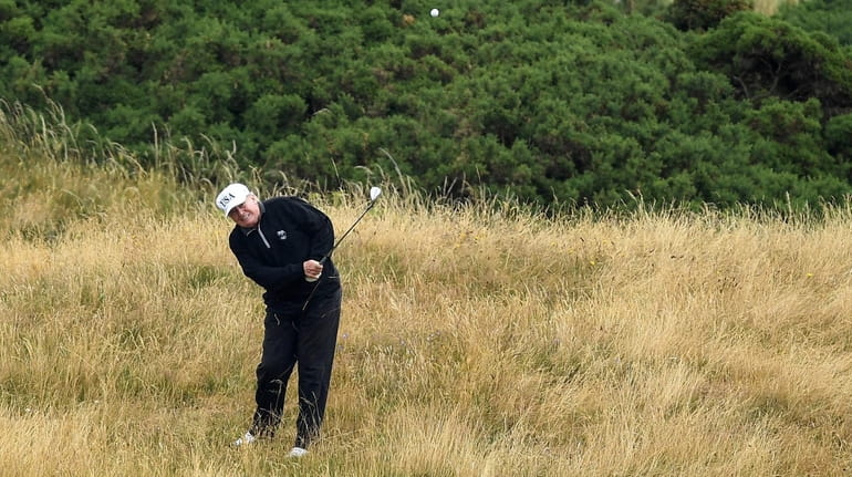 President Donald Trump plays a round of golf in 2018...
