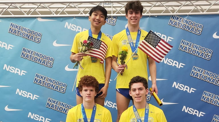 Port Washington's 4x800 relay team poses after winning the national...