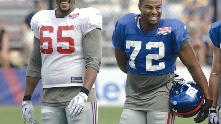 Will Beatty shares a laugh with Osi Umenyiora as they...