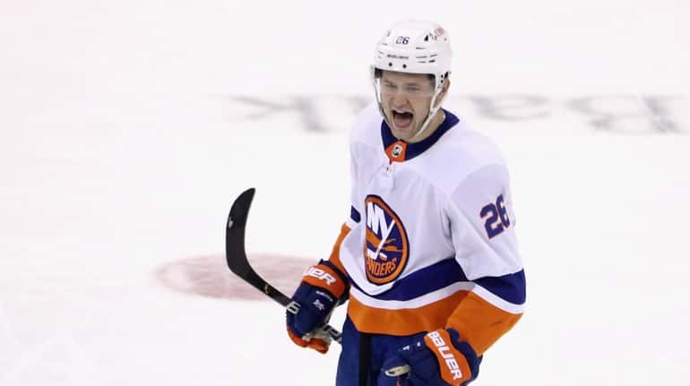 Oliver Wahlstrom #26 of the Islanders celebrates his game-winning shootout goal...
