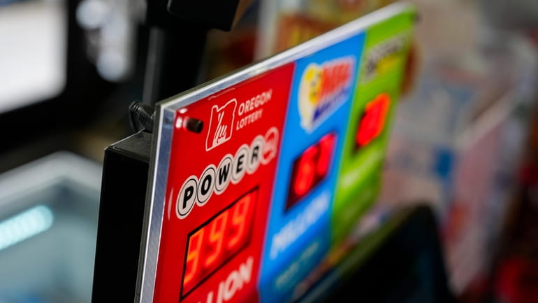 A sign for the Powerball jackpot is displayed at a...