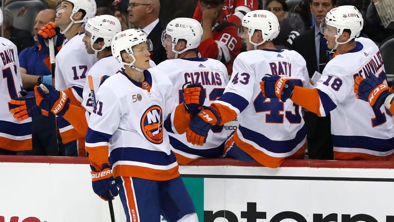 Islanders right wing Nikita Soshnikov (41) is congratulated after scoring...