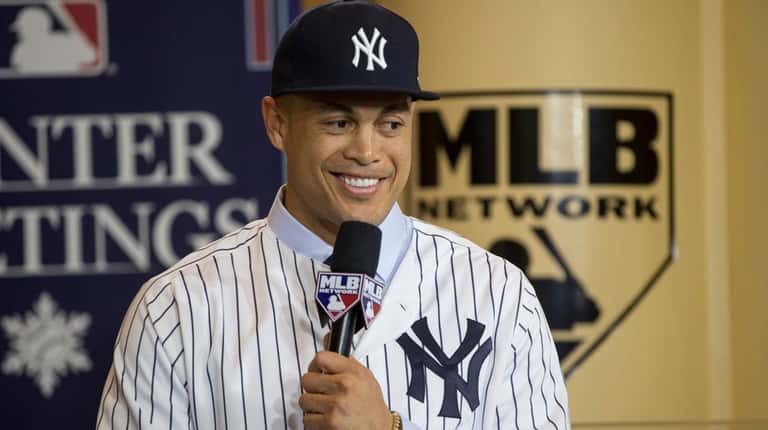 New Yankee Giancarlo Stanton answers questions during a press conference...
