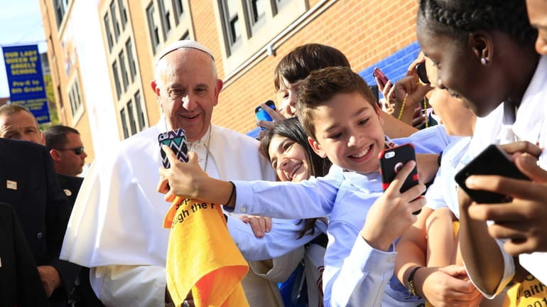 Pope Francis stops for a selfie at Our Lady Queen...