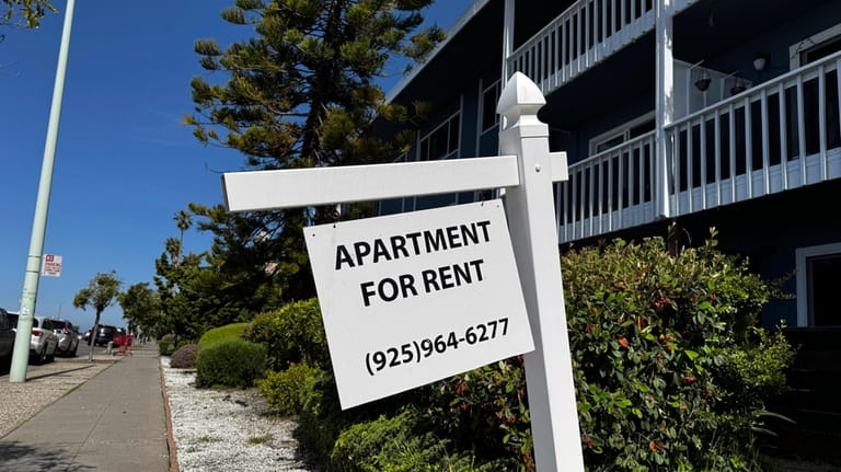 A sign sits outside an apartment building in Alameda, Calif....