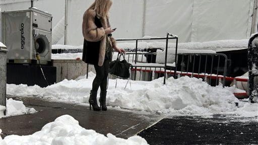 A woman checks her mobile phone outside Lincoln Center. (Feb....