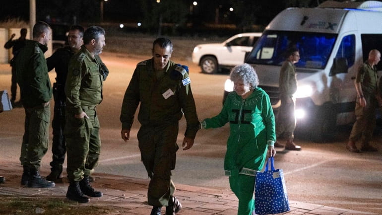 Ruth Munder, a released Israeli hostage, walks with an Israeli...
