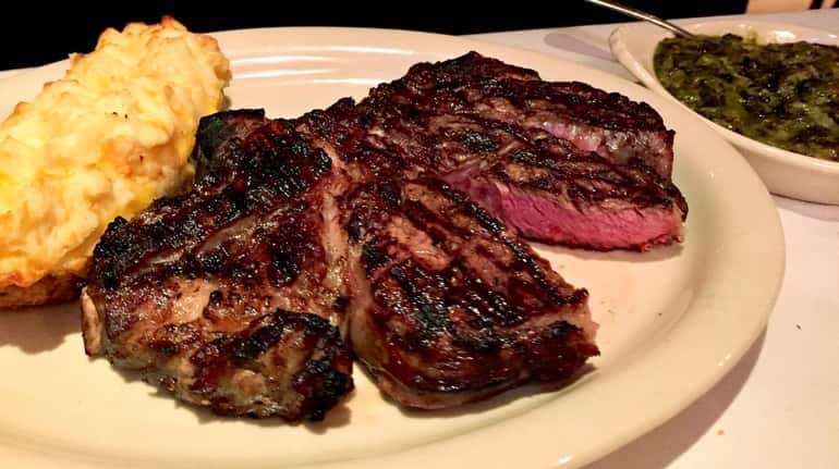 Rib-eye steak with double-stuffed potato at The Clubhouse in Huntington.