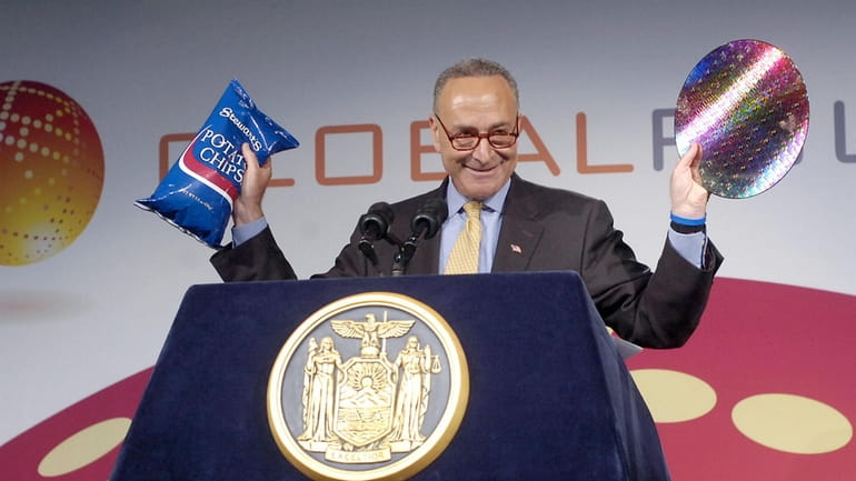 Sen. Charles Schumer, D-NY, compares the potato chips made in...