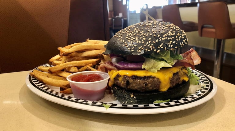 A bacon cheeseburger at Bethpage Burger Bar, served on a...