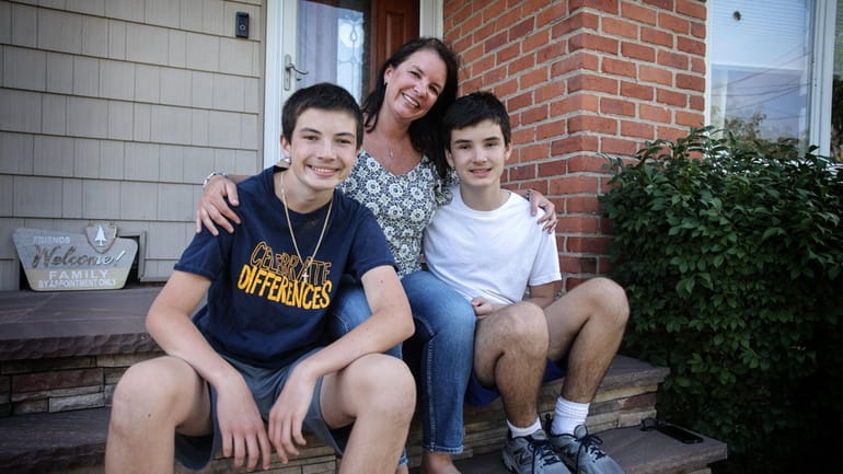 Siblings JT O’Fee, left, and Ryan O’Fee with their mother, Debbie O’Fee,...