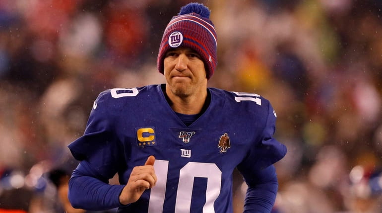 Eli Manning of the Giants runs to the locker room...