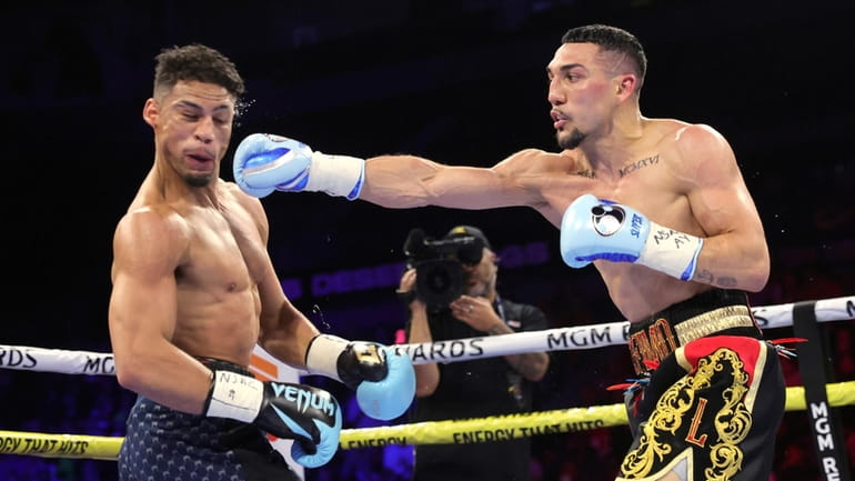 Teofimo Lopez, right, connects with a punch to Jamaine Ortiz...