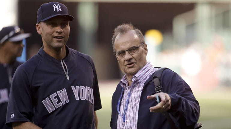 Former Yankees manager Joe Torre, right, and Yankees' Derek Jeter...