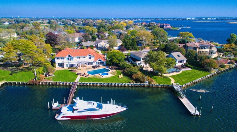 The waterfront Hewlett Harbor home  is listed for $4.495 million.
