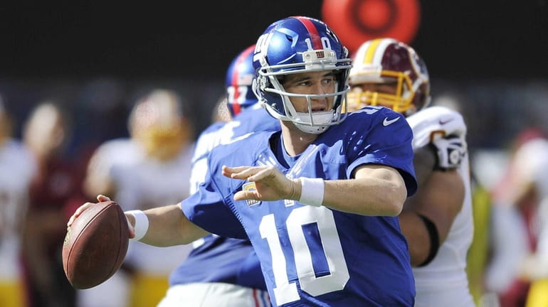 Giants quarterback Eli Manning looks to pass during the first...