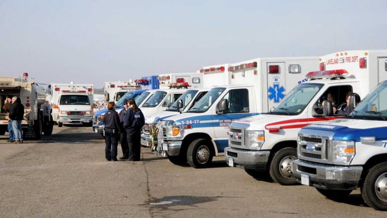 Emergency vehicles assemble at a command post at Brookhaven Airport...