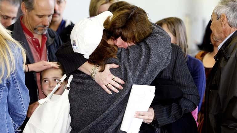 Diane DiMartino, right, hugs Donna DiMartino after Ronald Thornton was...