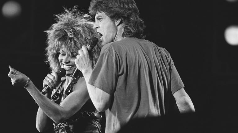 Singer Tina Turner, left, and Mick Jagger perform together during...