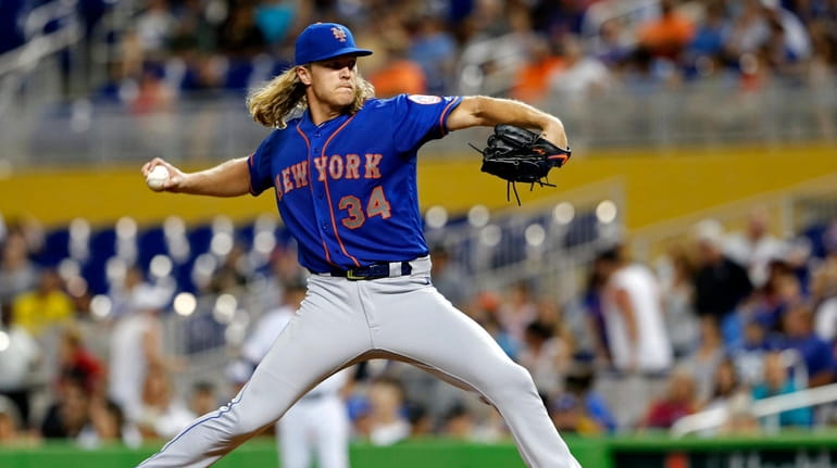 Mets starting pitcher Noah Syndergaard throws against the Miami Marlins...