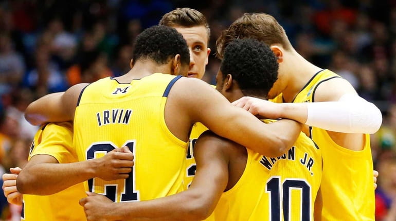 The Michigan Wolverines huddle before their game against the Tulsa...
