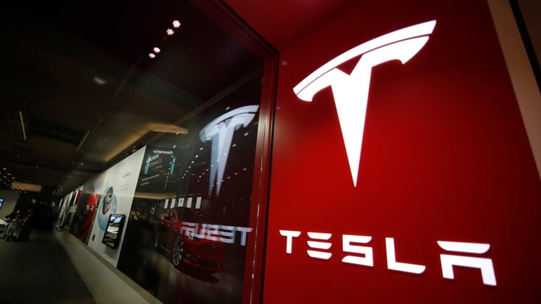 The Tesla logo is displayed at the company's store in...