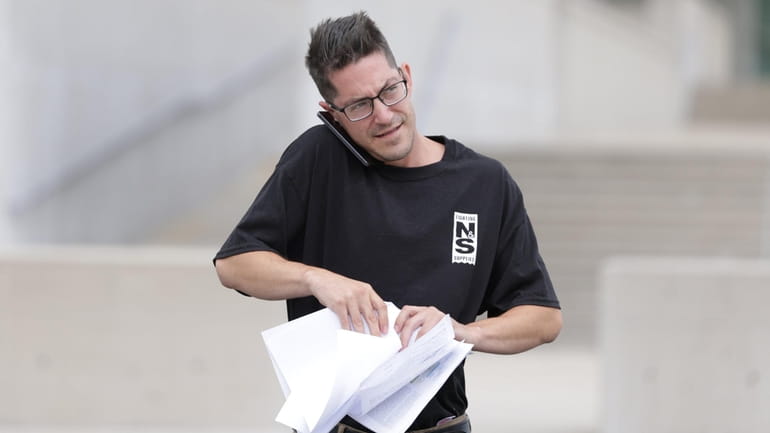 Matthew Schmitz of Lindenhurst leaves federal court in Central Islip after posting...